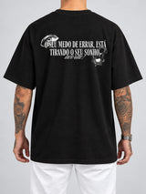 Cor: Preto | Costas | Oversized — Camiseta Seu Medo de Errar Está Tirando o Seu Sonho, Acorde (Verso)
